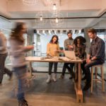 Employees collaborating and moving in an office.