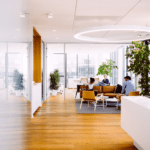 Three people sitting in a sunlit office.